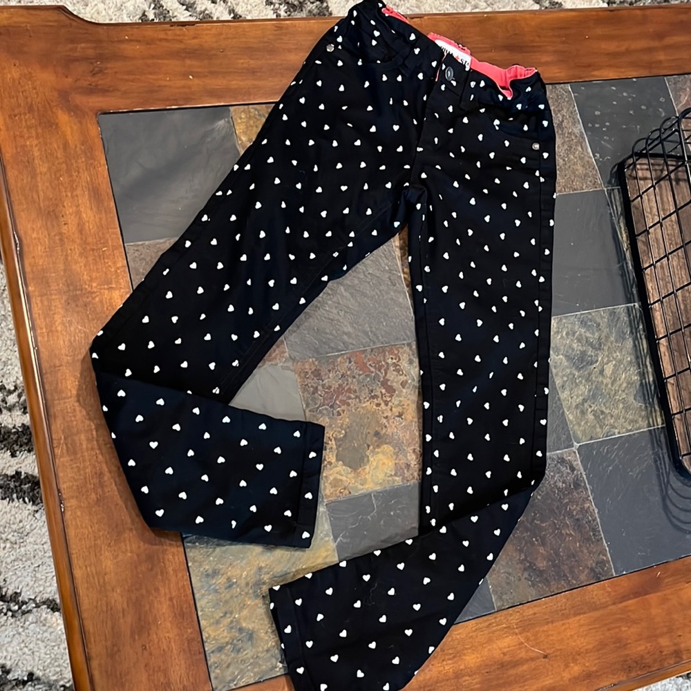 Girls straight leg black pants with white hearts. Size 10
